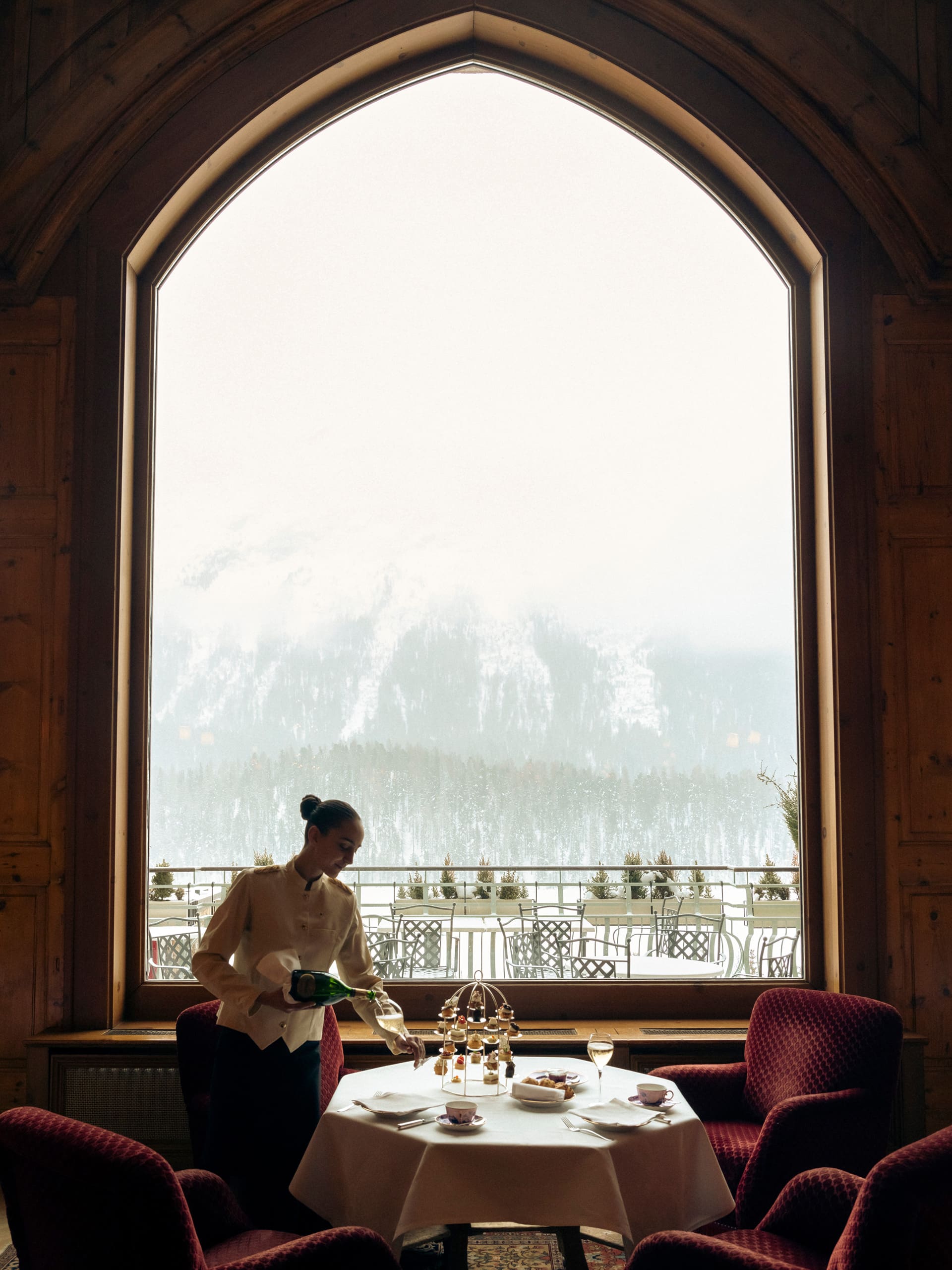 Badrutts Palace Food And Beverage Restaurants Le Grand Hall Window Mountain View Waitress Afternoon Tea